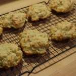 Dice butter and chill in freezer. Preheat oven to 400 degrees F. Sift flour, baking powder and salt into large bowl and mix well. Add diced butter and mix with hands until there are pebble sized balls of butter. Add shredded cheese and thyme then whisk together until mixed well and evenly distributed. Add buttermilk and use a fork to mix until ingredients are combined to a sticky dough. Careful not to overmix. Drop 1/4 cup sized balls of dough on a greased baking sheet. Bake for 15-20 minutes on top shelf of oven until the edges are brown. Pull out of the oven and top with additional shredded cheese or just dig in and enjoy!