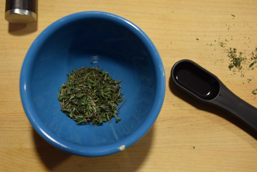 Freshly chopped thyme in a blue dish.