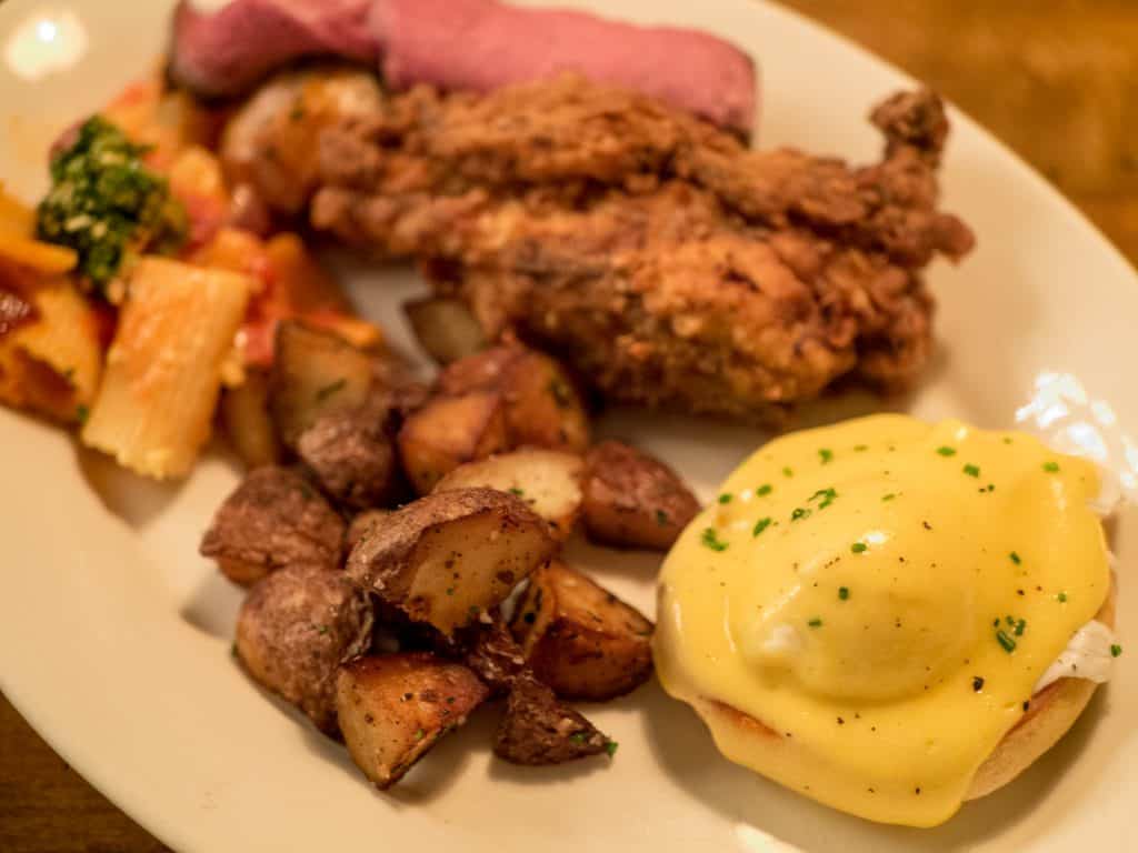 Plate of food featuring eggs benedict for brunch at The barn at rocky fork creek restaurant