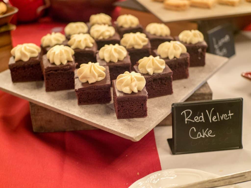 Red velvet cake squares at the barn restaurant on a serving square over a red tablecloth.
