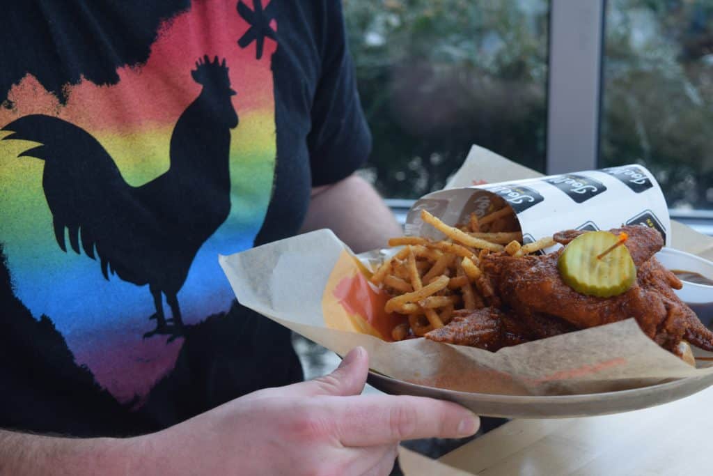 Joellas Hot Chicken Indianapolis, IN wearing hot chicken takeover pride shirt from Columbus, Ohio