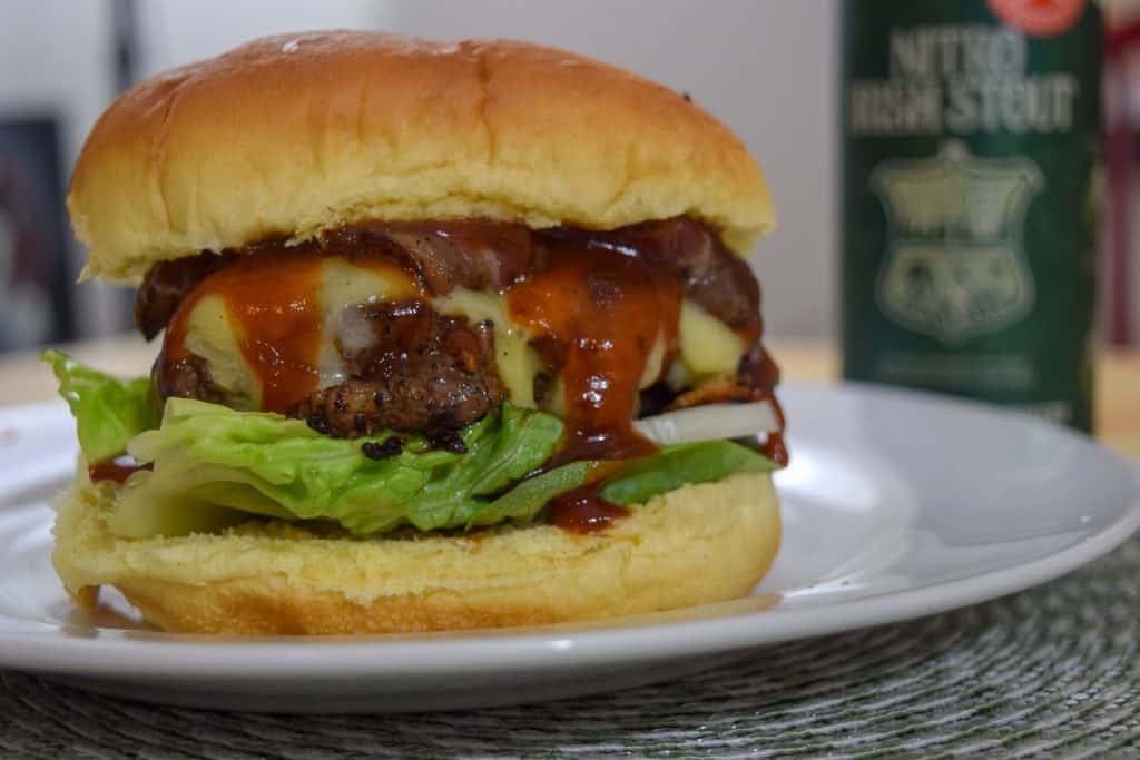 Irish pub burgers are a delicious way to celebrate St. Patty's Day! These beef burgers have Irish Cheddar, a homemade stout bbq sauce, and bacon on them. Serve with boiled salted potatoes. This Irish pub burger recipe is pretty simple and definitely delicious. Find the recipe on The Beard and The Baker. 