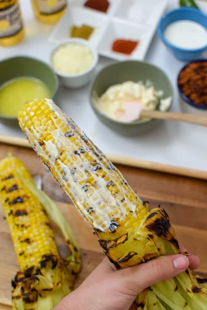 This homemade elote aka Mexican Street Corn is so delicious an so easy to make! It's the most perfect way to spend a summer afternoon. Load it up with your favorite toppings like bacon and chorizo! 