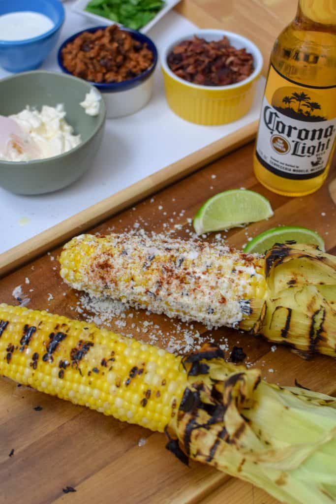 This homemade elote aka Mexican Street Corn is so delicious an so easy to make! It's the most perfect way to spend a summer afternoon. Load it up with your favorite toppings like bacon and chorizo! 