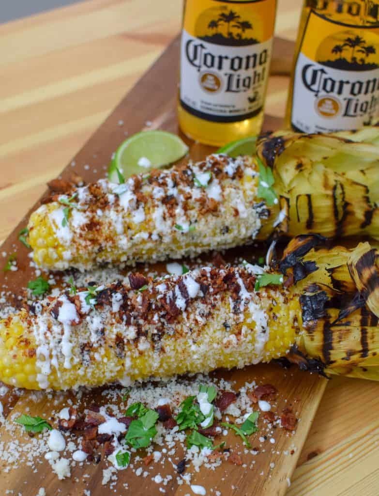 This homemade elote aka Mexican Street Corn is so delicious an so easy to make! It's the most perfect way to spend a summer afternoon. Load it up with your favorite toppings like bacon and chorizo! 