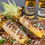 This homemade elote aka Mexican Street Corn is so delicious an so easy to make! It's the most perfect way to spend a summer afternoon. Load it up with your favorite toppings like bacon and chorizo!