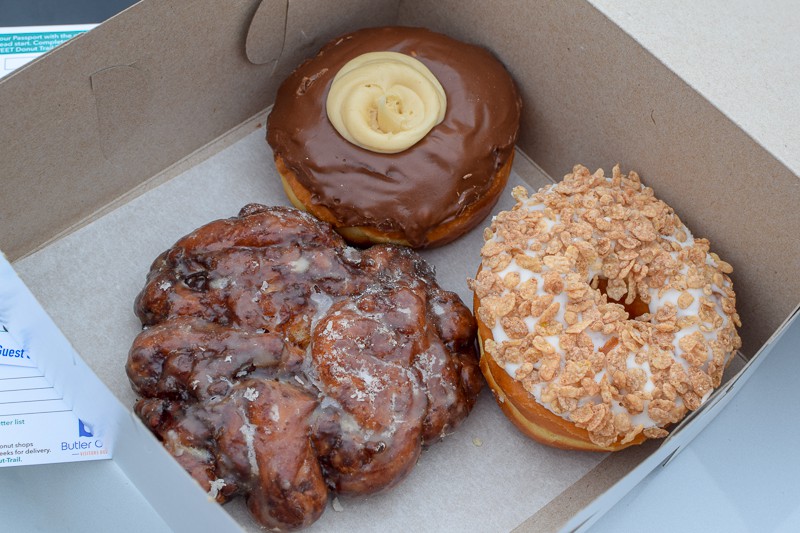 3 donuts in a carryout box from Kelly's Bakery Donuts & More in Butler County, Ohio.