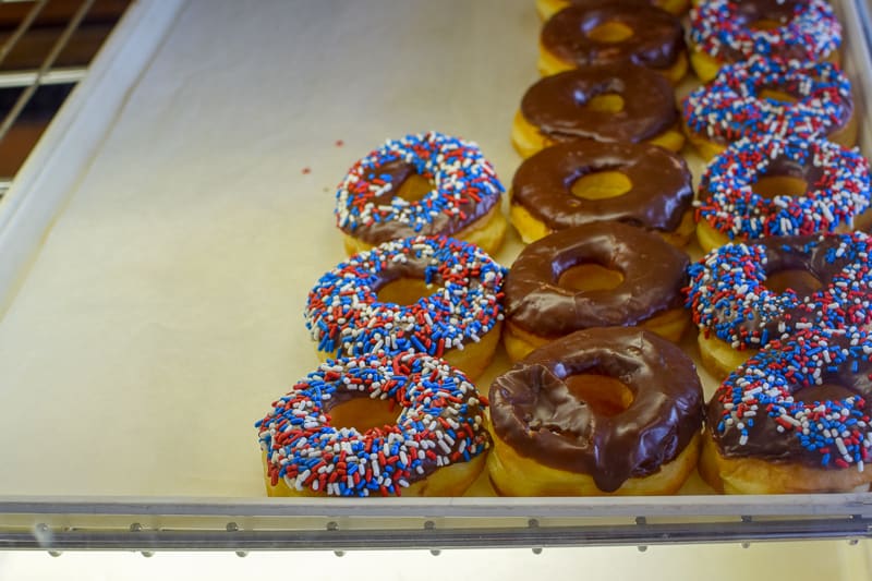 Tray of iced donuts in the bakery case from Stan The Donut Man.