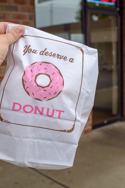 To go bag with a pink sprinkled donut graphic from Stan The Donut Man.