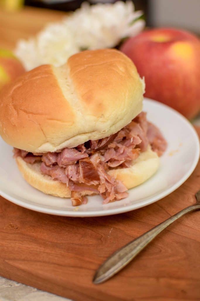 This homemade smoked turkey sandwich is topped with a delicious tangy and spicy apple bbq sauce. The sandwich is made with smoked turkey drumsticks, chopped and tossed on a soft bun. For extra deliciousness, serve with white cheddar cheese and fresh jalapenos. 