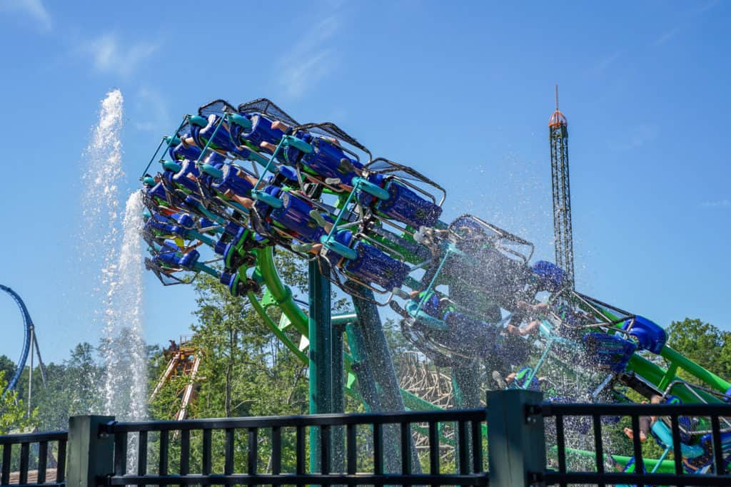 Roller coaster going around turn near fountain water in the kids area of Dollywood.