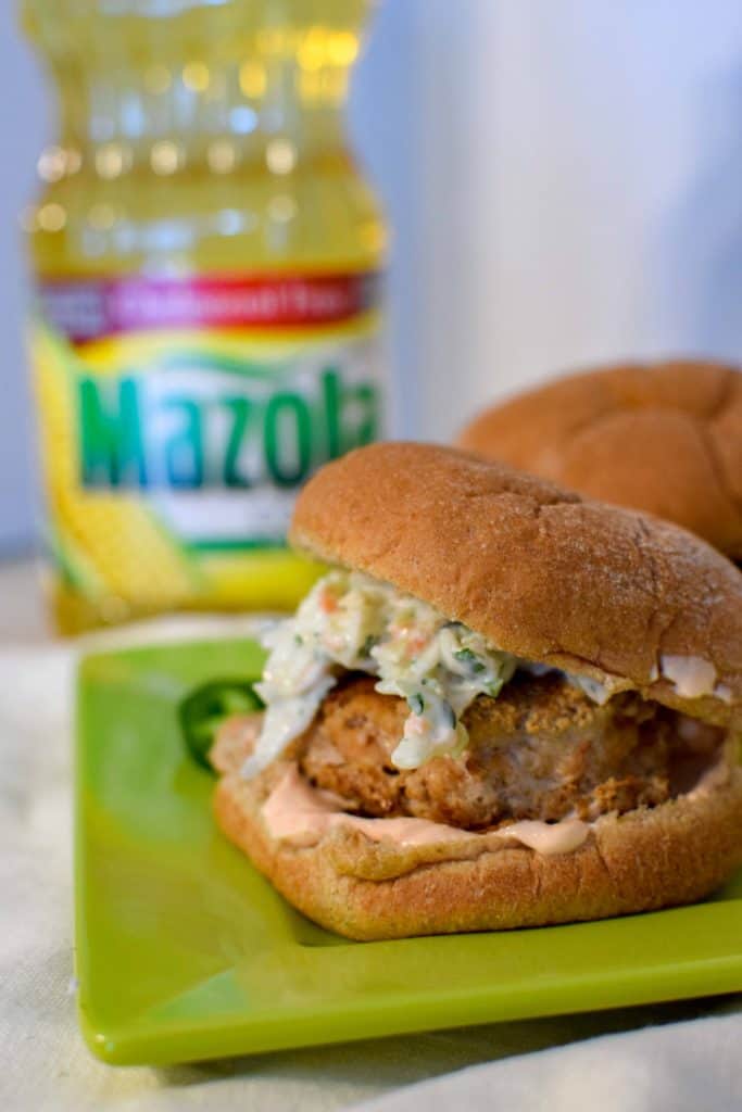 These homemade juicy turkey burgers are easy to make and full of flavor. They are made with ground turkey and topped with a homemade creamy jalapeño slaw and sriracha mayo, both made with greek yogurt for a healthier option. 