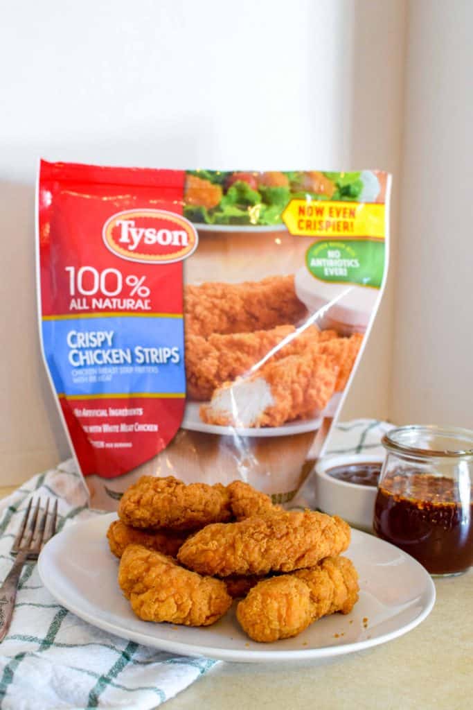 Tyson chicken strips on a plate to eat with dipping sauces.