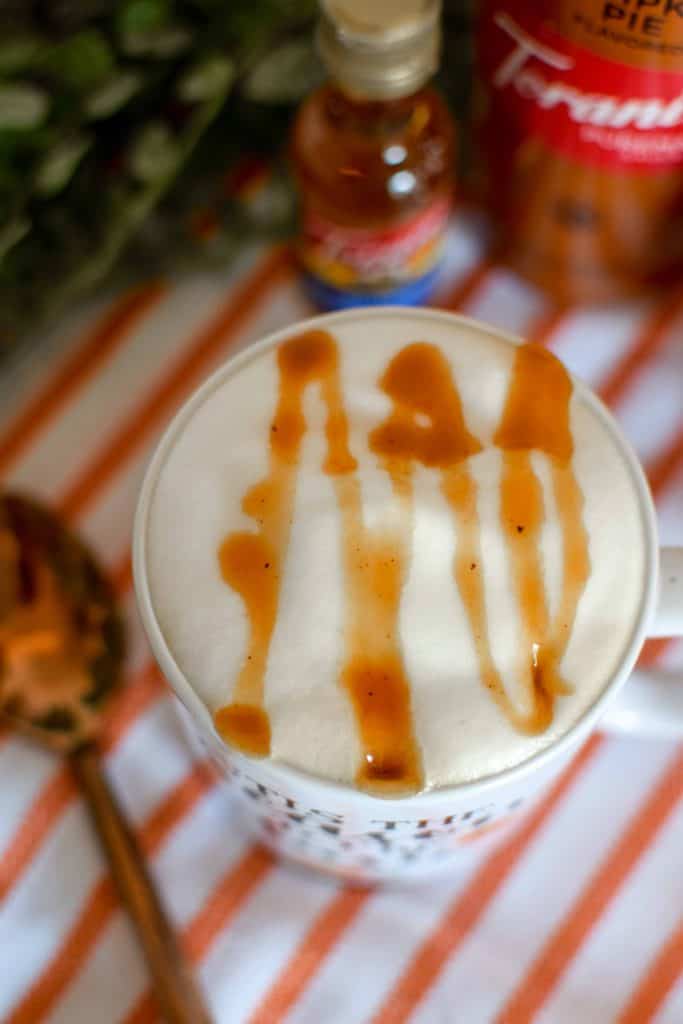 Latte topped with caramel sauce.