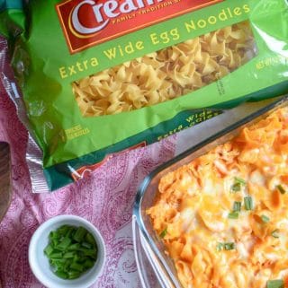 Homemade buffalo chicken casserole made with egg noodles, topped with green onions.