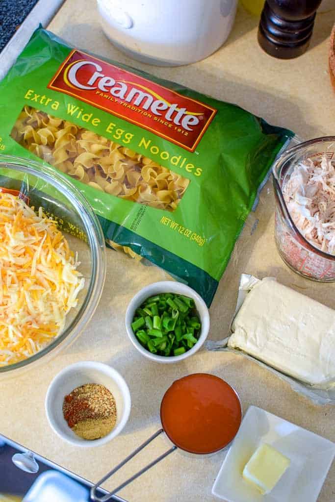 All of the ingredients for buffalo chicken casserole laid out on a kitchen counter before assembling the recipe.