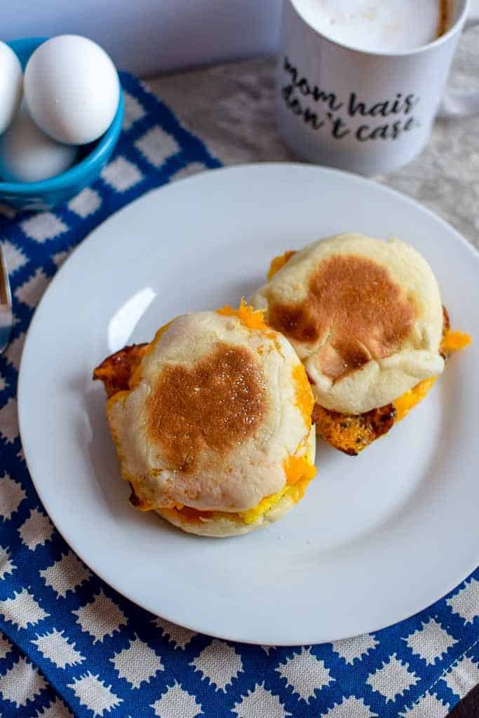These breakfast sandwiches are a perfect way to use bacon or sausage! They can be stored in the freezer for an easy and simple breakfast so you can skip the drive thru. 