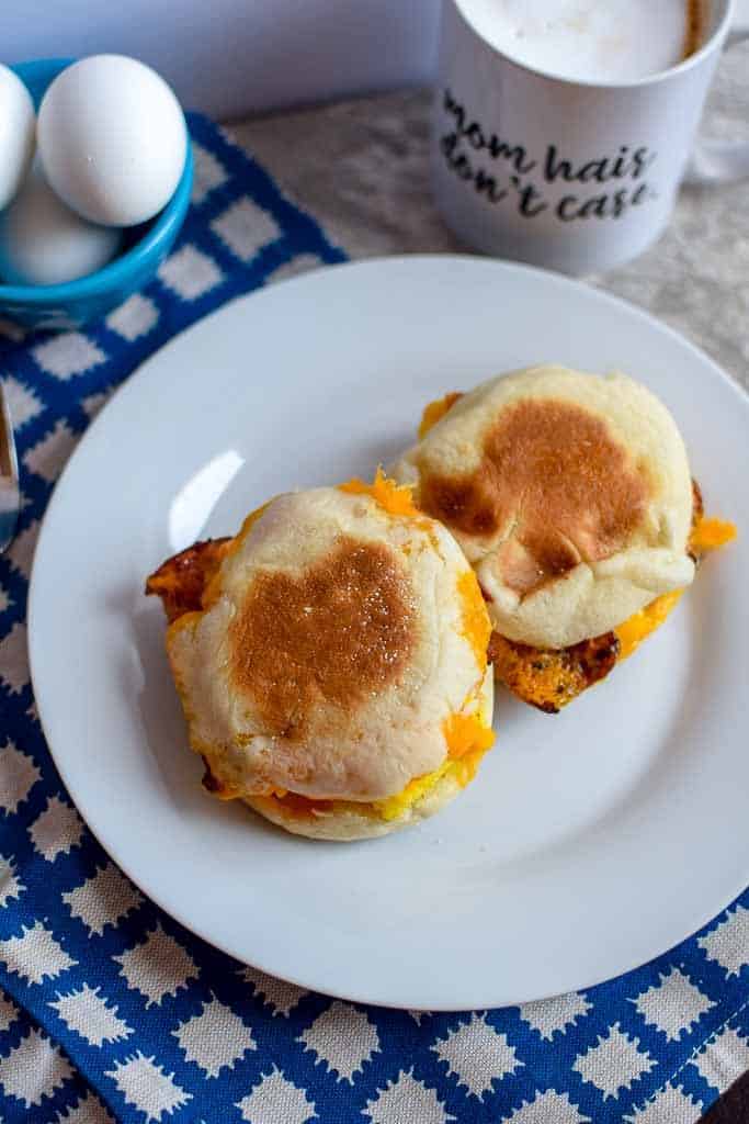 These breakfast sandwiches are a perfect way to use bacon or sausage! They can be stored in the freezer for an easy and simple breakfast so you can skip the drive thru. 