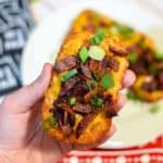 loaded hash brown potato skins with cheese and bacon and green onions.