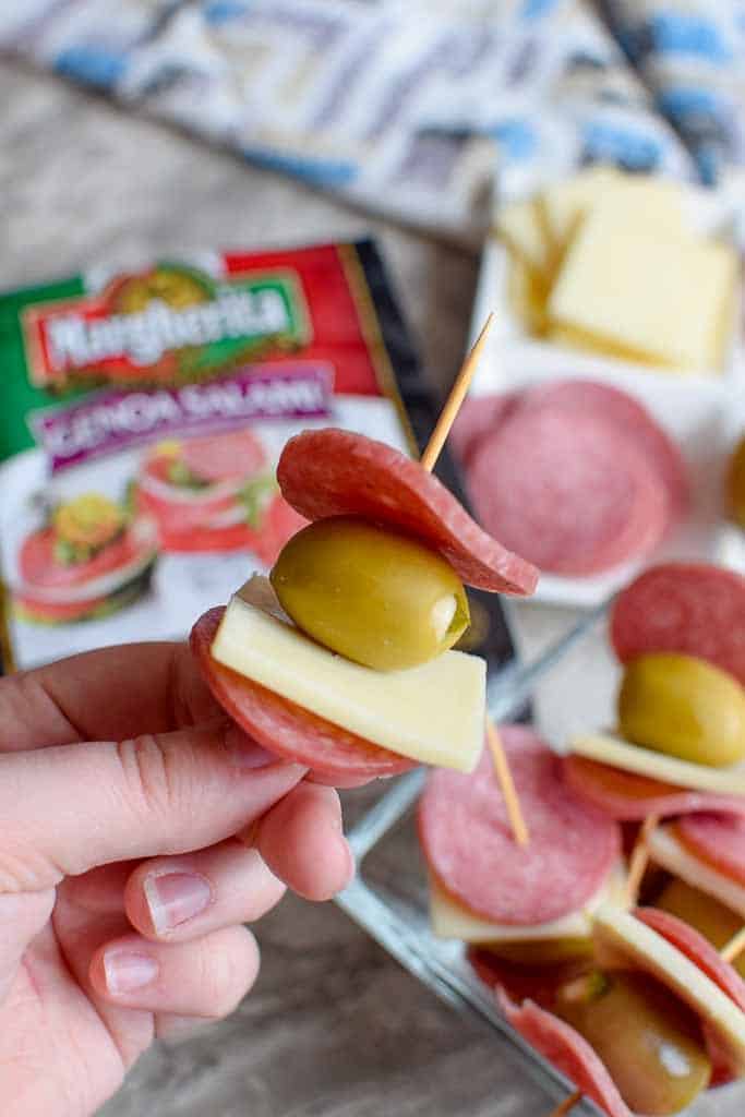 Homemade weekend snack made with Margherita Genoa salami, white cheddar cheese, and large green olives.
