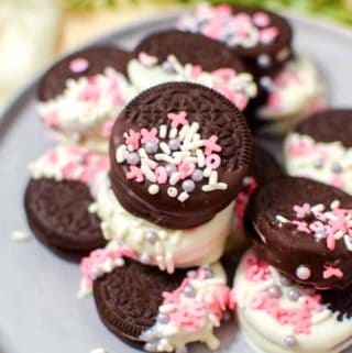 Milk and white chocolate dipped Oreos with Valentine's Day sprinkles.