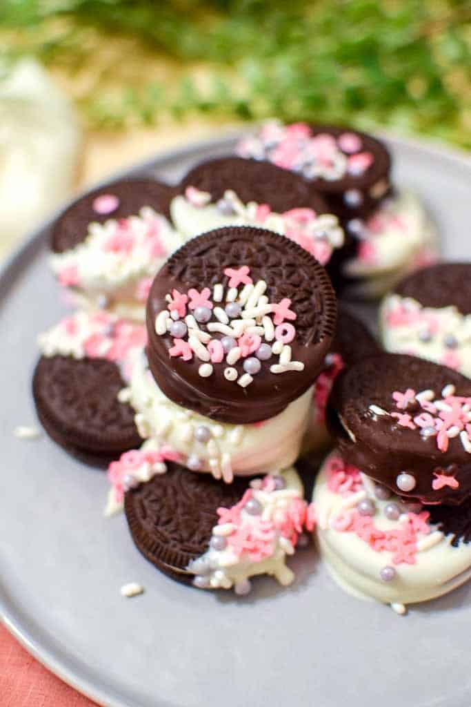 Milk and white chocolate dipped Oreos with Valentine's Day sprinkles.