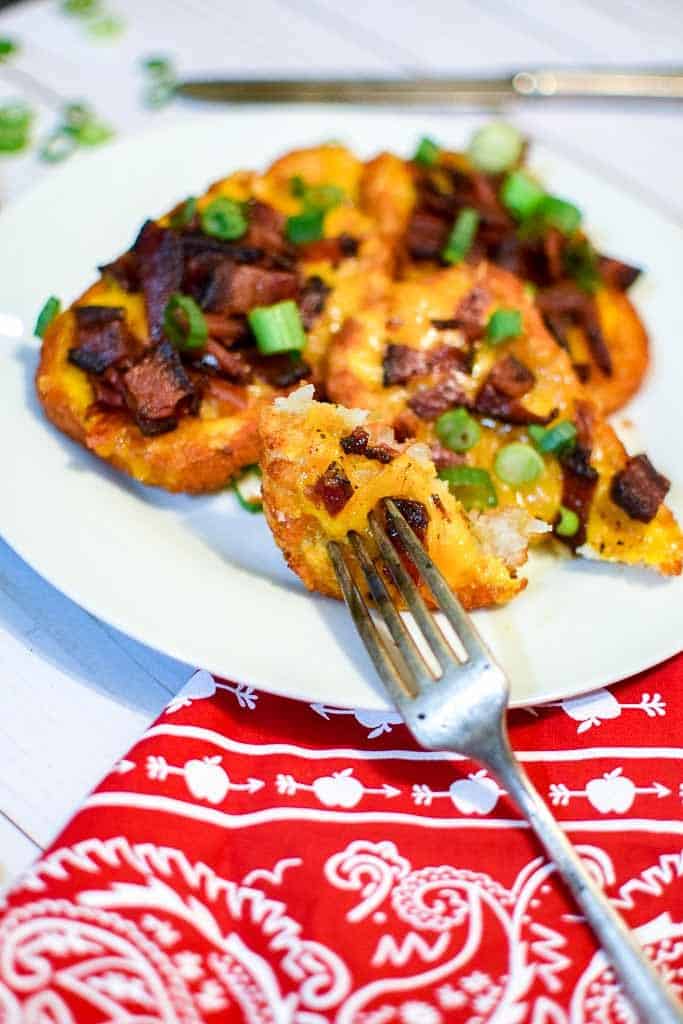 Loaded hash brown potato skins with cheese, bacon, and green onions.
