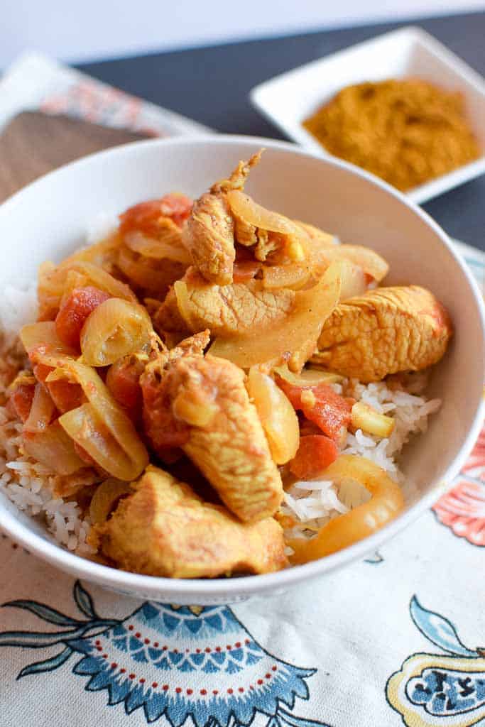 Closeup of curry over rice in bowl.