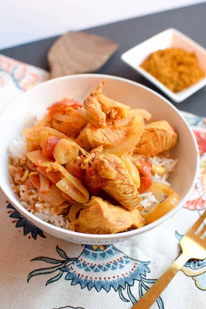 Finished recipe for chicken curry served with rice.