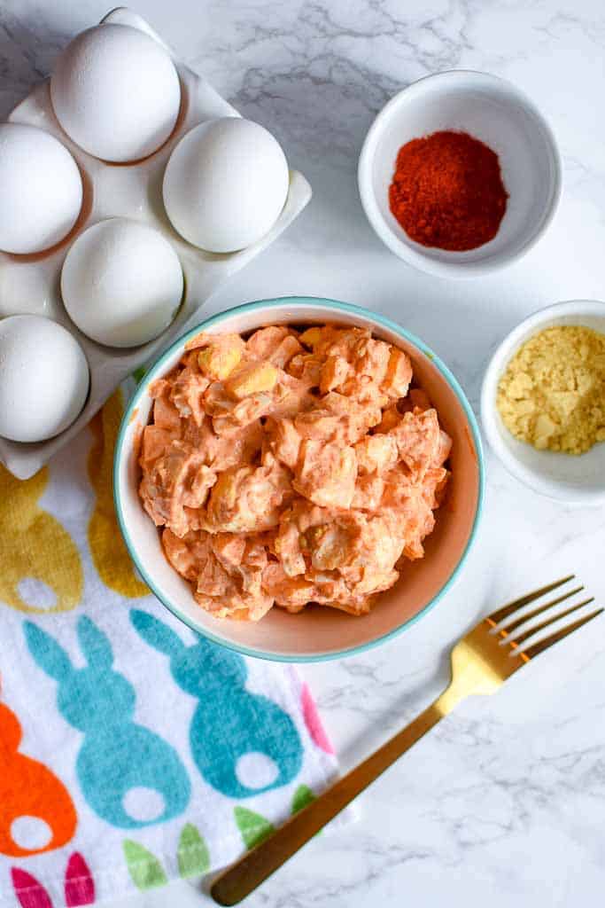 This 4 ingredient deviled egg salad recipe is so easy and so delicious. Hard boiled eggs, mayo, paprika, and ground mustard are all it takes to have a tasty deviled egg salad that you can enjoy for Easter. It’s a simple recipe for egg salad that you can enjoy on it’s own or as an egg salad sandwich.