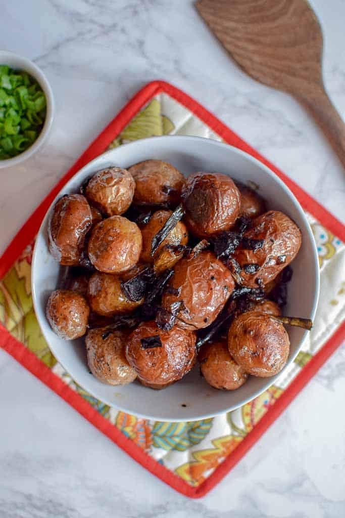 These homemade grilled small potatoes are made with lamb bacon and green onions! They are the most delicious side dish for your summer cookout. 
