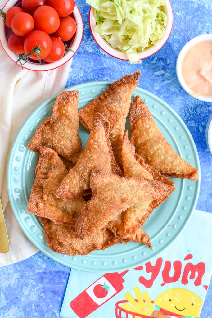 These fried cheeseburger bites are the perfect addition to your summer menu! The cheesy bites are made in wonton wrappers so they have the perfect crunch to them. Serve with your favorite cheeseburger condiment like ketchup, mustard, or secret sauce! 