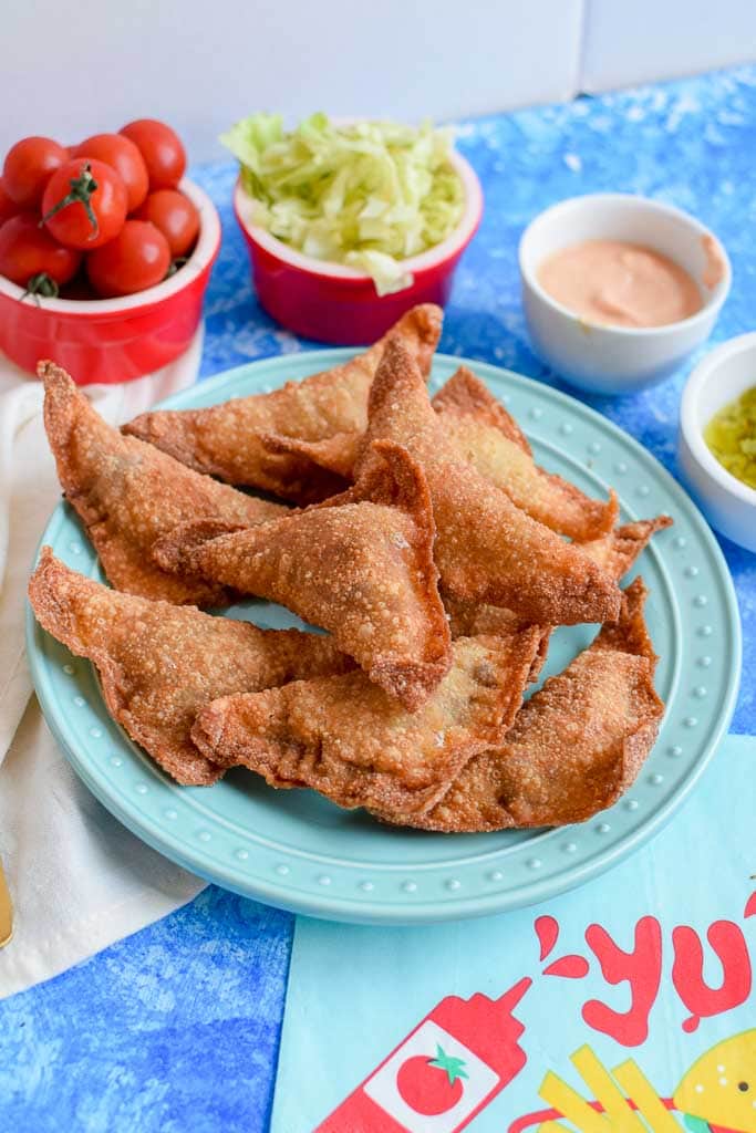 These fried cheeseburger bites are the perfect addition to your summer menu! The cheesy bites are made in wonton wrappers so they have the perfect crunch to them. Serve with your favorite cheeseburger condiment like ketchup, mustard, or secret sauce!