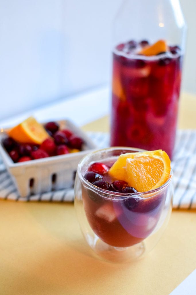 This winter sangria mocktail recipe is incredibly simple to make, absolutely delicious, and filled with fruit like pears, cranberries, oranges, and raspberries! It's perfect for a small crowd or just for one.