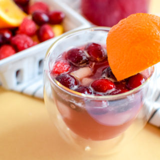 This winter sangria mocktail recipe is incredibly simple to make, absolutely delicious, and filled with fruit like pears, cranberries, oranges, and raspberries! It's perfect for a small crowd or just for one.