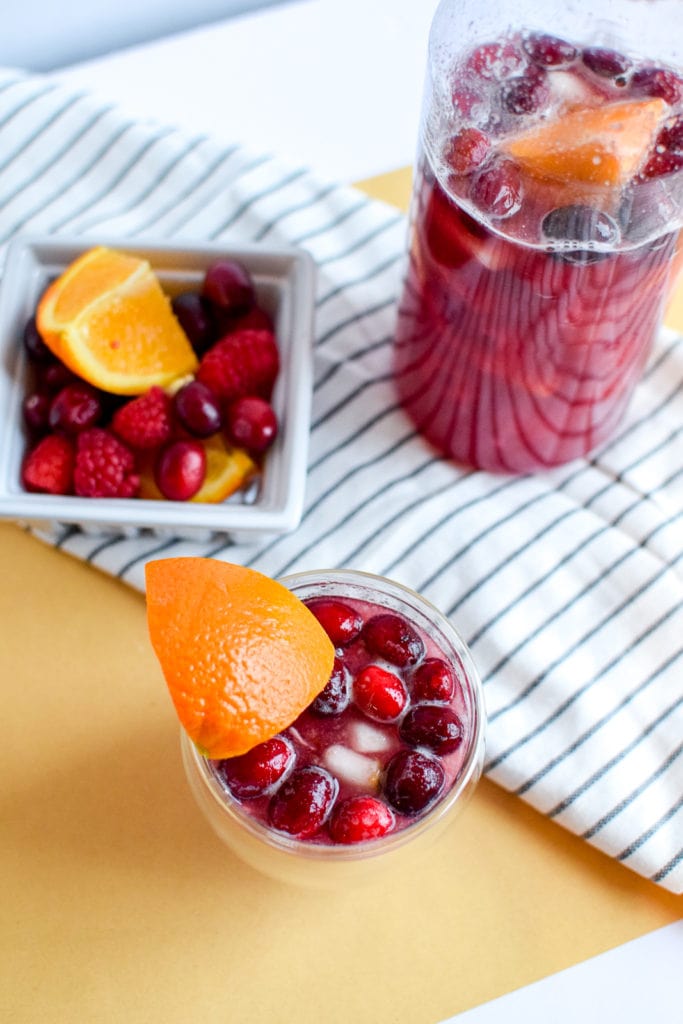 This winter sangria mocktail recipe is incredibly simple to make, absolutely delicious, and filled with fruit like pears, cranberries, oranges, and raspberries! It's perfect for a small crowd or just for one.