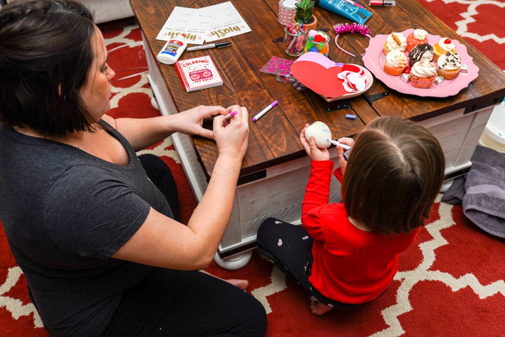 Mother and daughter doing a craft.