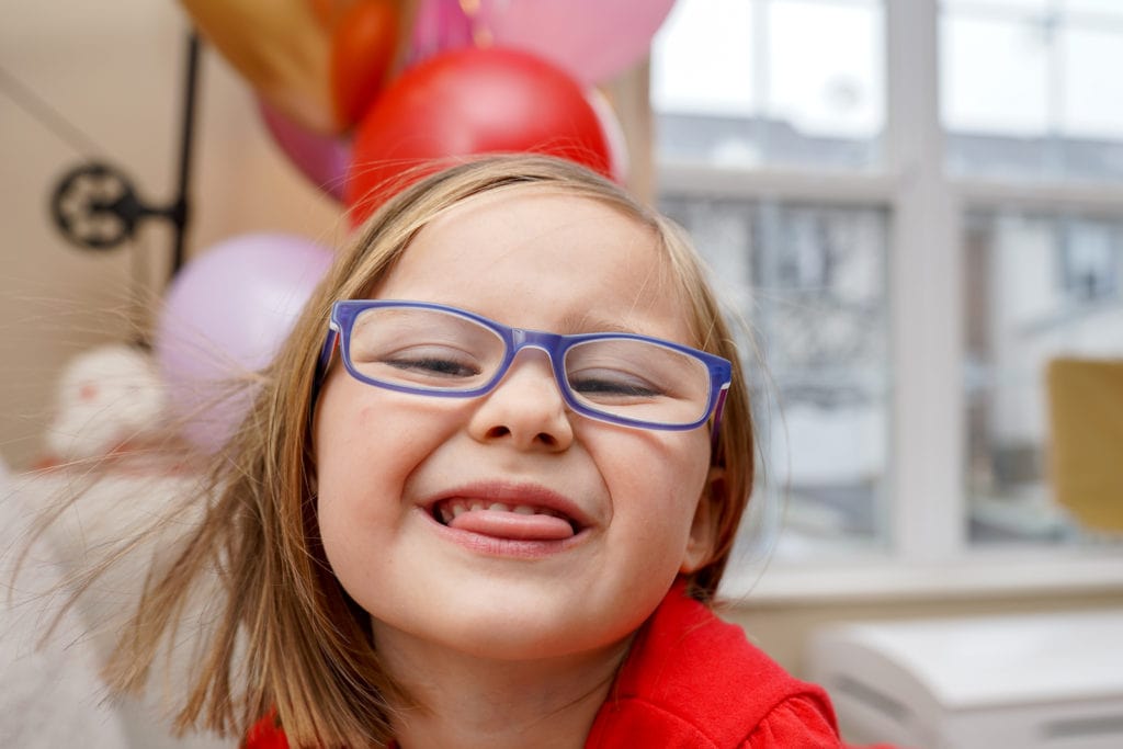 Child smiling while celebrating valentine's day.