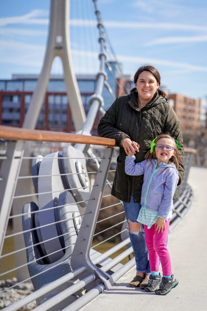 Mother and daughter on suspension bridge at Bridge Park in Dublin, Ohio.