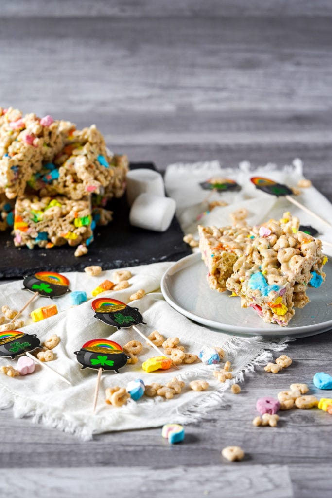 Lucky charms bars stacked on a slate tray.