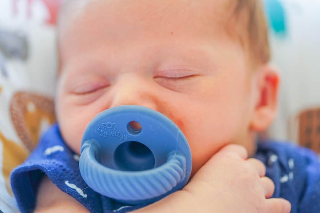 Newborn at hospital with Itzy Ritzy Binky.