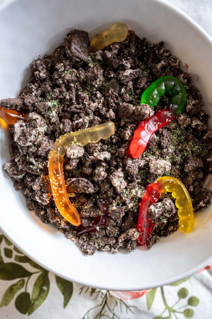 Dirt pudding in a bowl with gummi worms.