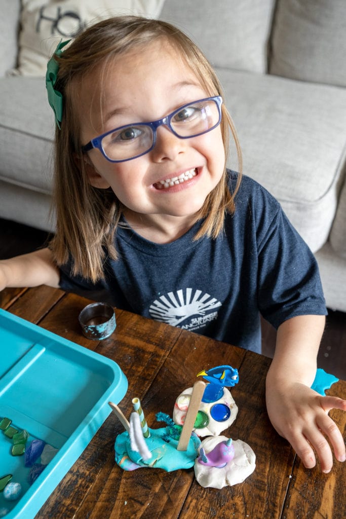 Child playing with clay inside.