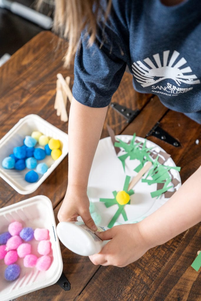 Child gluing during craft activity.