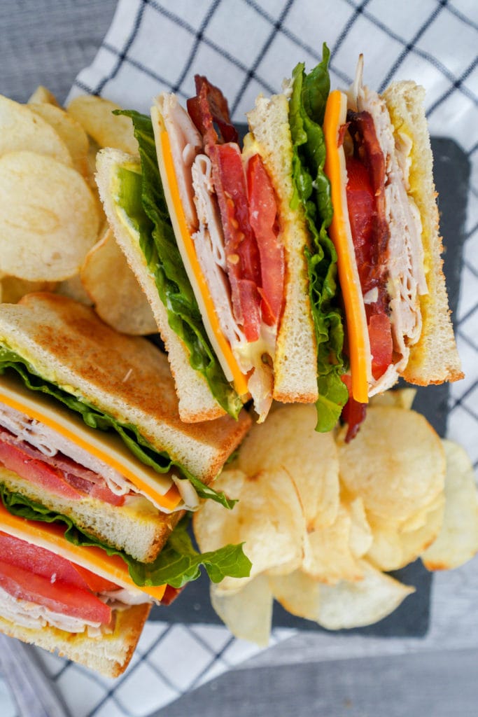 Pork free club sandwich with chips.