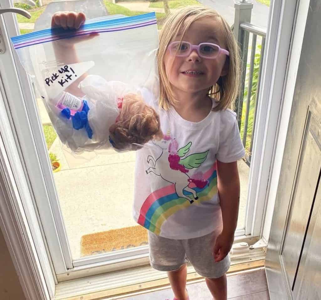 Child picking up litter for earth day.