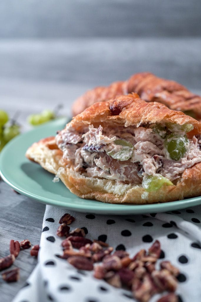 Closeup of chicken salad on a fresh croissant.