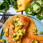 We love our air fryer so very much and love this recipe utilizing it so very much! Top these fish tostadas with a fresh mango salsa for a super easy lunch or dinner that the whole family will enjoy.