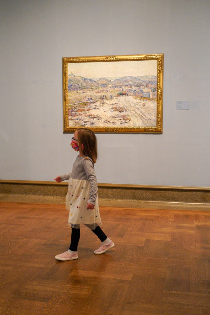 Child walking through exhibits inside the Columbus Museum Of Art.