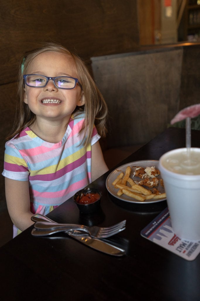 Child eating inside Pat and Gracies kitchen and tavern.